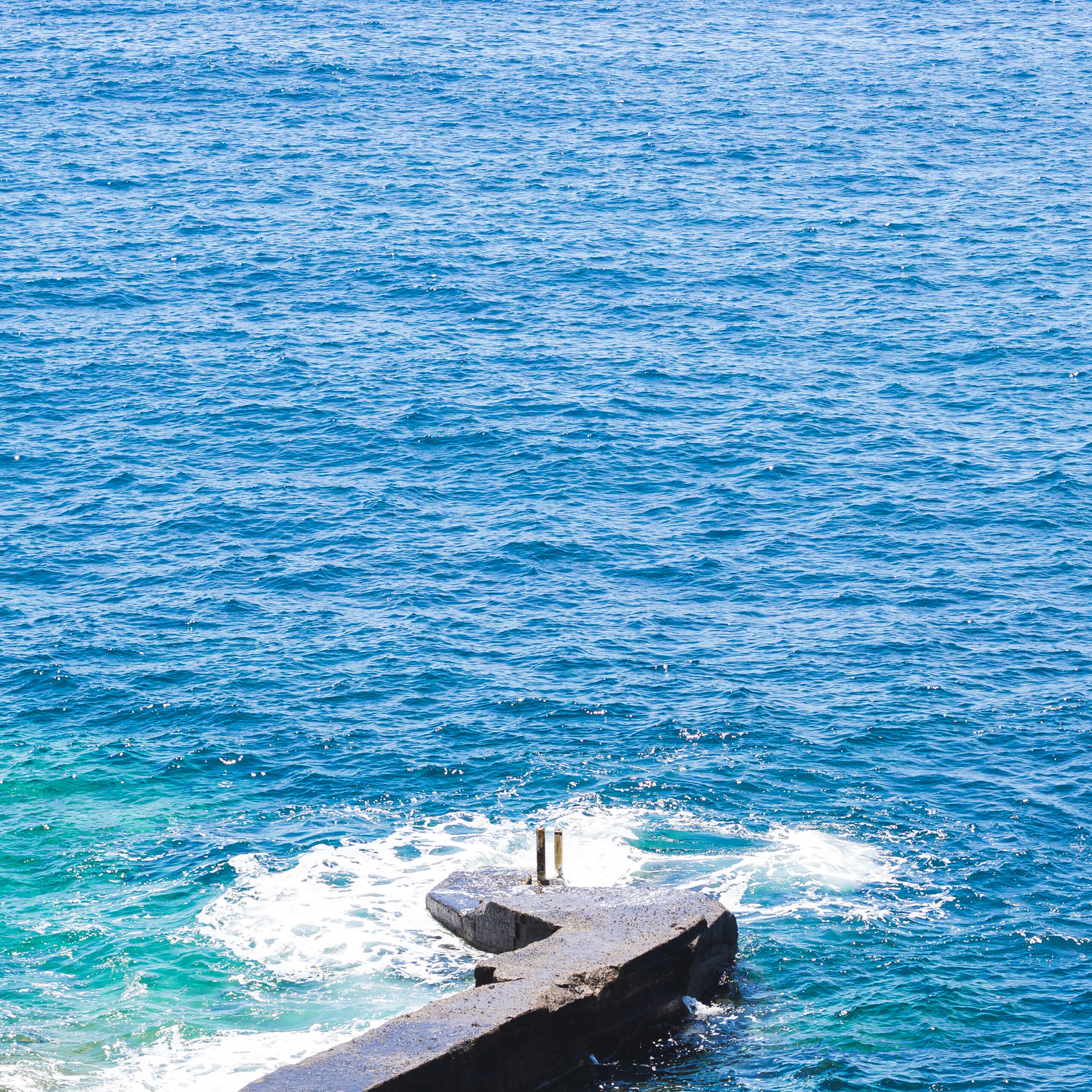 Swimming in the clear turquoise waters near the Santorini volcanic islands