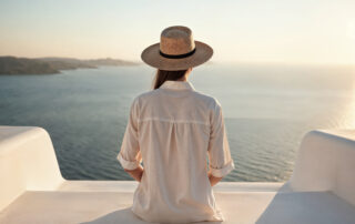 Woman enjoying the Santorini caldera view on a romantic getaway